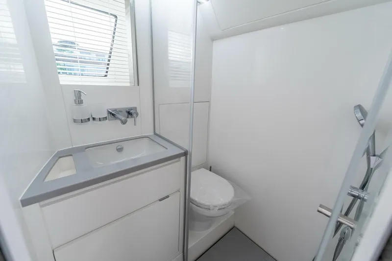 Yacht Photos Pics Modern yacht bathroom with sleek design, featuring a sink, toilet, and shower in Limitless Seas XLV 45.