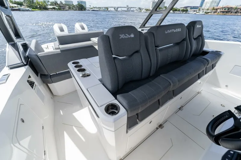 Yacht Photos Pics Luxury seating on Limitless Seas XLV 45 boat, 2025 model, with cup holders and waterfront view.