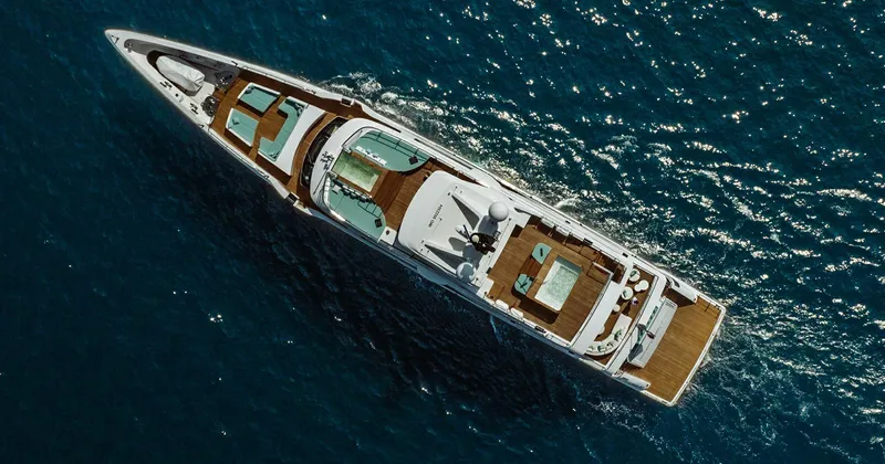  Yacht Photos Pics Aerial view of 2020 Benetti Seagull yacht cruising on blue ocean waters.