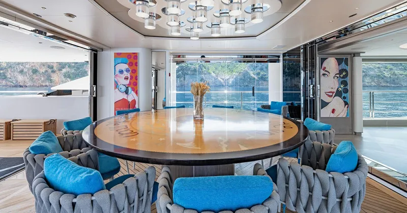  Yacht Photos Pics Luxurious Benetti Seagull yacht interior with modern art, round table, and plush seating, 2020 model.