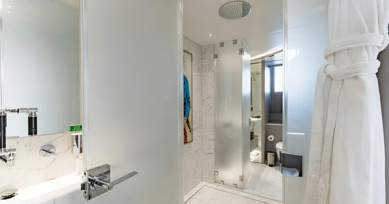  Yacht Photos Pics Luxurious bathroom on 2020 Benetti Seagull yacht with modern fixtures and frosted glass doors.