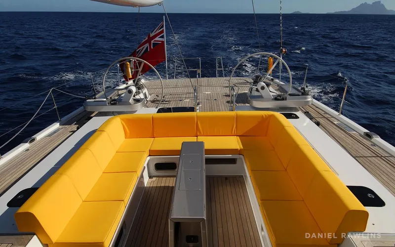 Whimsy Yacht Photos Pics Luxurious 2005 custom yacht with yellow seating, open sea view, and dual steering wheels.