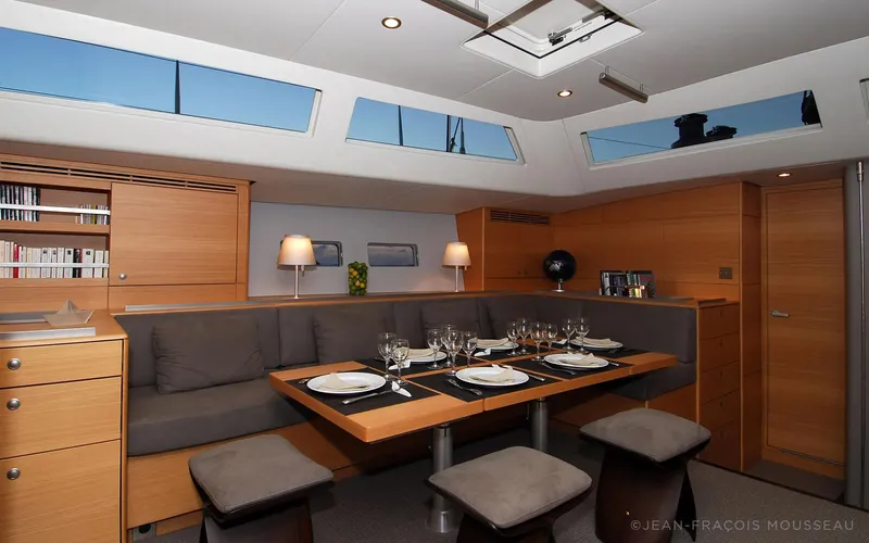 Whimsy Yacht Photos Pics Luxurious yacht interior with elegant dining area, modern design, and ample natural light.