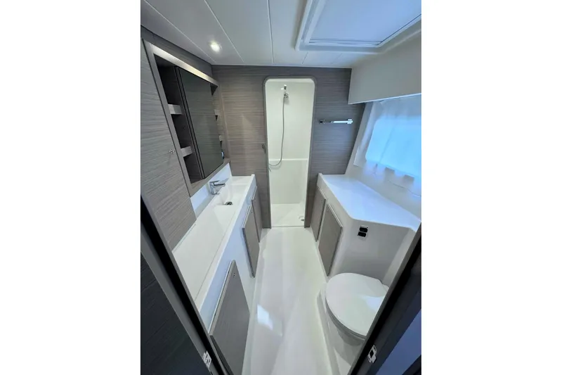  Yacht Photos Pics Modern bathroom interior of 2024 Lagoon 42 yacht, featuring sleek design and ample storage.