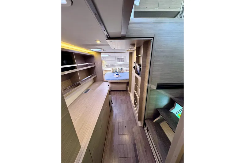  Yacht Photos Pics 2024 Lagoon 42 interior cabin with modern wood finish and cozy sleeping area.