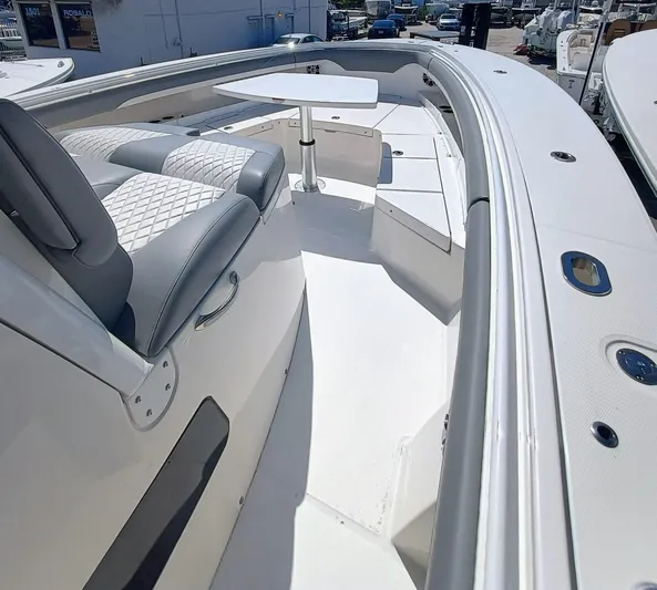 37-029 Yacht Photos Pics 2024 Regulator 37 boat interior with cushioned seating and table.