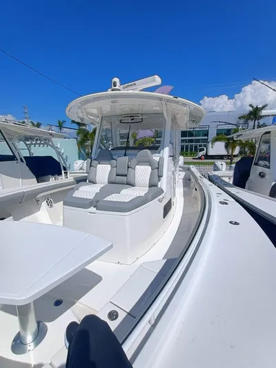 37-029 Yacht Photos Pics 2024 Regulator 37 boat with luxurious seating and modern design under a clear blue sky.