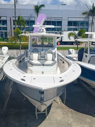  Yacht Photos Pics 2024 Regulator 37 boat displayed at a dealership, featuring sleek design and modern seating.
