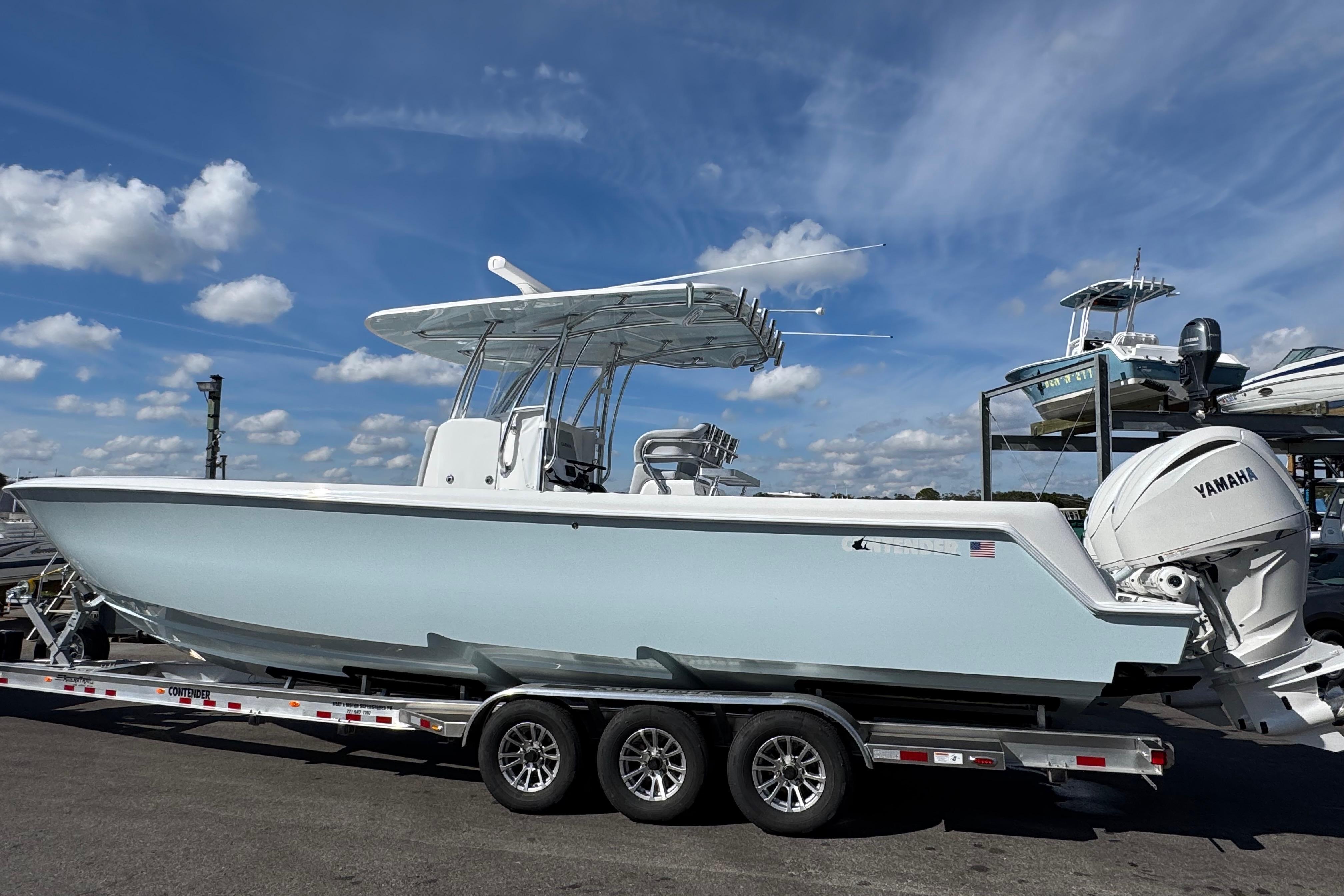 2026 Contender 35 ST boat on trailer with Yamaha engines, under a clear blue sky.