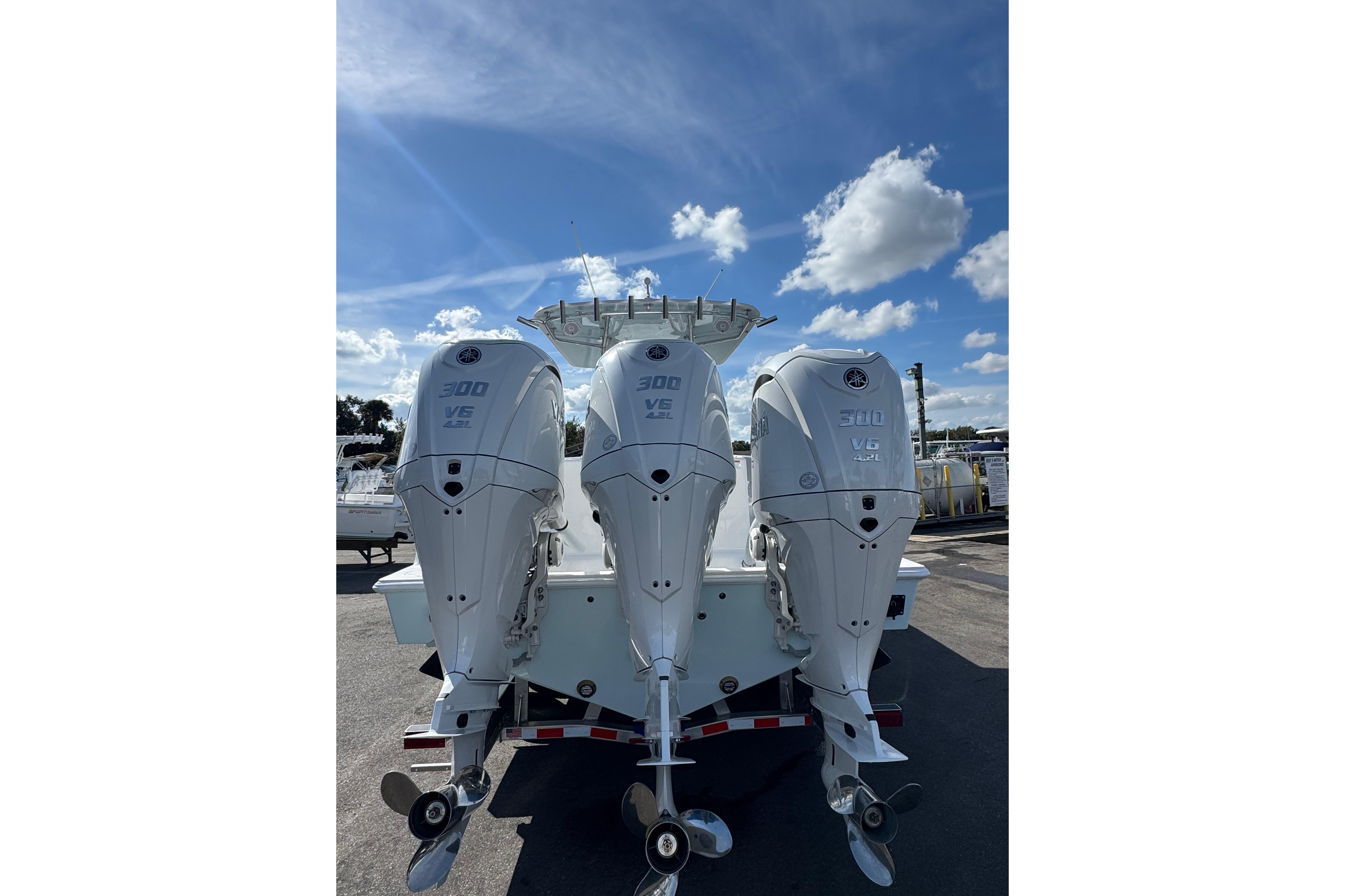 2026 Contender 35 ST boat with triple 300 V6 outboard engines under a clear sky.