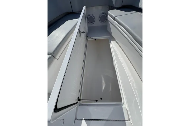  Yacht Photos Pics 2026 Contender 35 ST boat storage compartment with open hatch and cushioned seating.