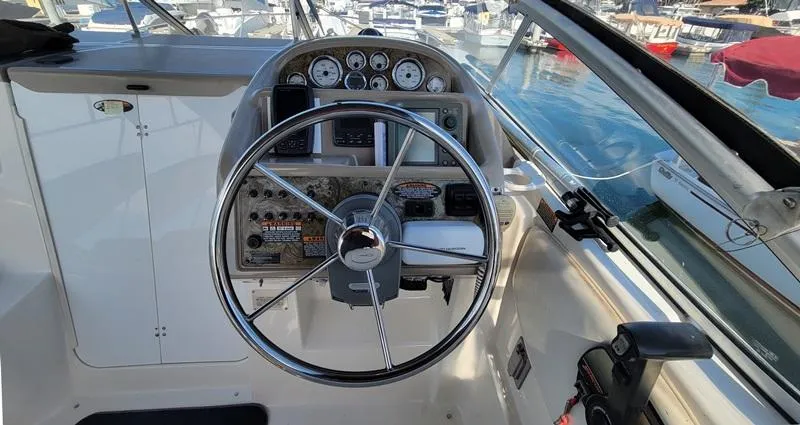 Hawley's Haven Yacht Photos Pics 2001 Bayliner 2855 Ciera boat helm with steering wheel and control panel, docked at marina.