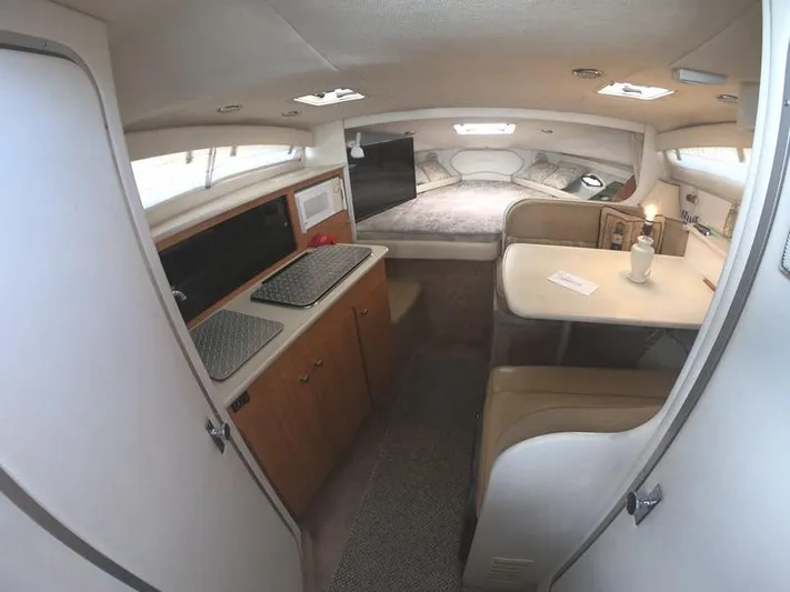 Hawley's Haven Yacht Photos Pics 2001 Bayliner 2855 Ciera cabin interior with kitchenette, dining area, and sleeping quarters.