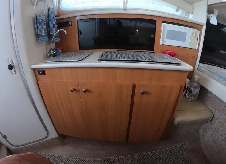 Hawley's Haven Yacht Photos Pics 2001 Bayliner 2855 Ciera interior kitchen with sink, microwave, and wooden cabinets.