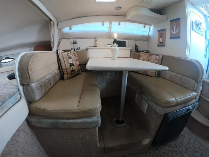 Hawley's Haven Yacht Photos Pics 2001 Bayliner 2855 Ciera interior with cozy dining area and beige seating.