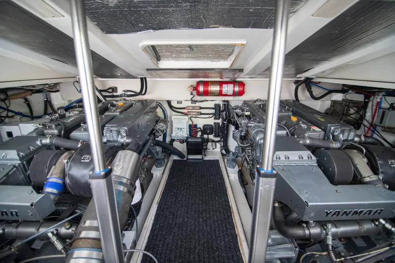 Lilli Ann Yacht Photos Pics Engine room of 2001 Rampage 38 Express with dual Yanmar engines and fire extinguisher.