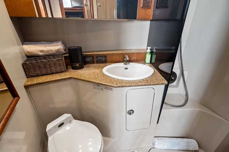 Lilli Ann Yacht Photos Pics Luxurious bathroom in 2001 Rampage 38 Express yacht with sink, toilet, and shower.