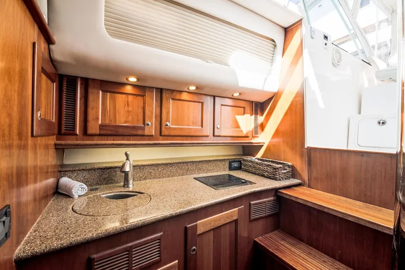 Lilli Ann Yacht Photos Pics Luxurious 2001 Rampage 38 Express yacht interior with wooden cabinetry and modern amenities.