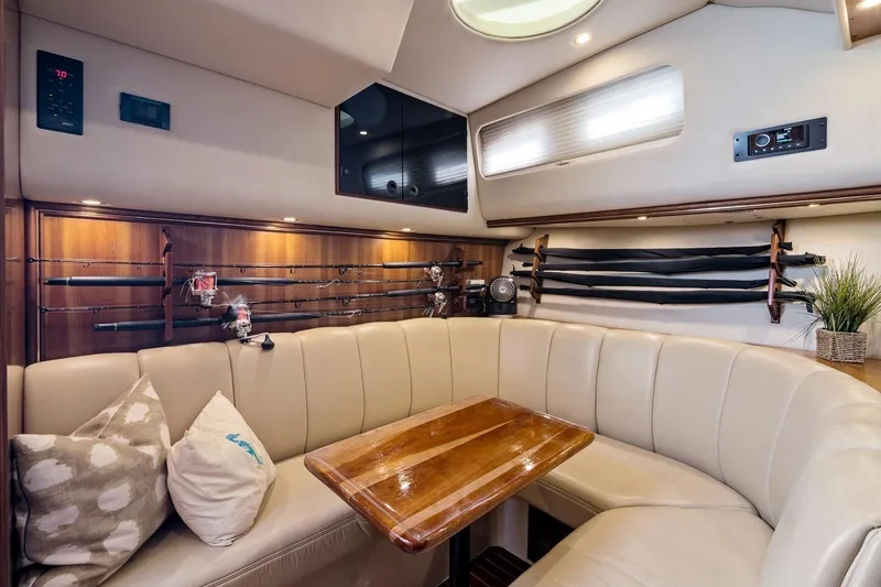 Lilli Ann Yacht Photos Pics Luxurious interior of 2001 Rampage 38 Express yacht with fishing rods and cozy seating.