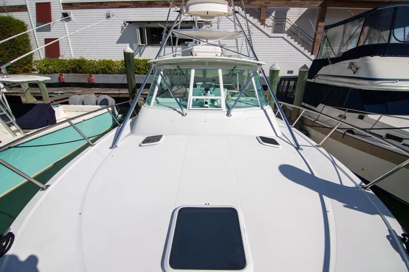 Lilli Ann Yacht Photos Pics 2001 Rampage 38 Express boat docked, showcasing spacious deck and sleek design.