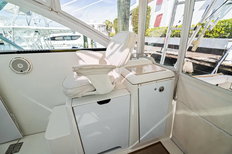 Lilli Ann Yacht Photos Pics 2001 Rampage 38 Express boat interior with white captain's chair and storage.