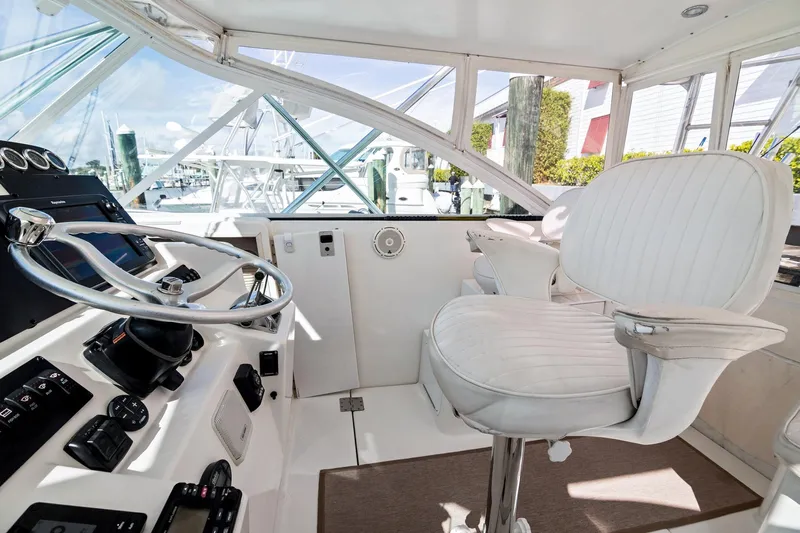 Lilli Ann Yacht Photos Pics 2001 Rampage 38 Express helm with white captain's chair and steering wheel.