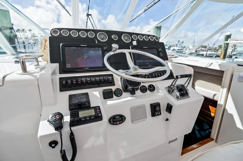 Lilli Ann Yacht Photos Pics Cockpit of 2001 Rampage 38 Express boat with steering wheel and navigation instruments.
