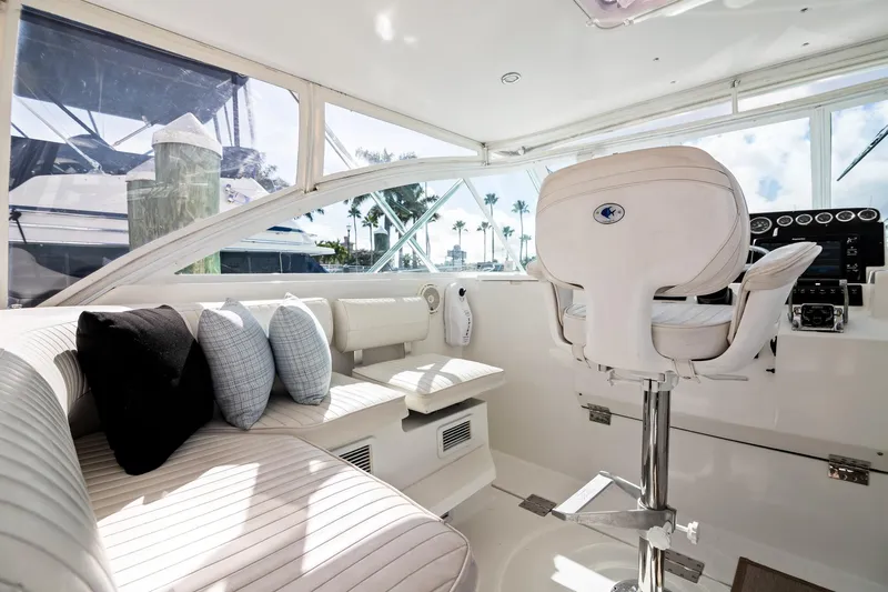 Lilli Ann Yacht Photos Pics Luxurious interior of 2001 Rampage 38 Express yacht with plush seating and helm.