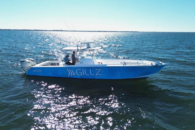  Yacht Photos Pics 2005 Jupiter 38 FS boat on open water, sunny day, blue hull with "Gillz" branding.