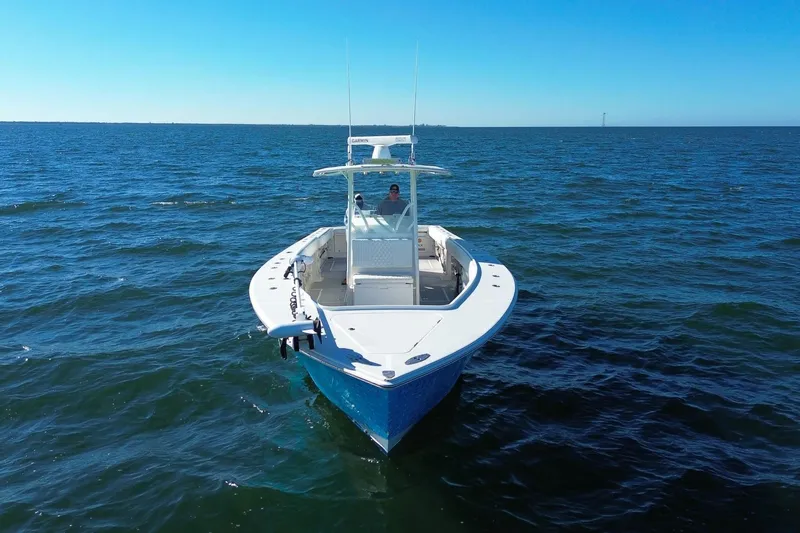  Yacht Photos Pics 2005 Jupiter 38 FS boat cruising on open water under clear blue skies.