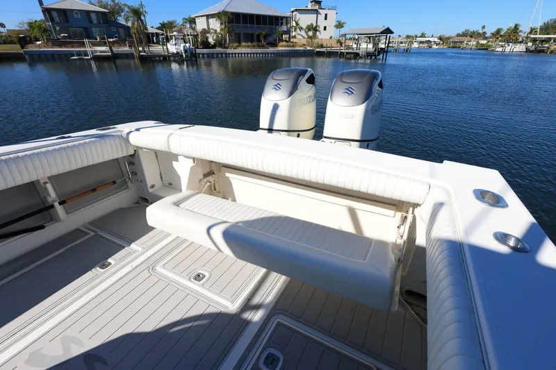  Yacht Photos Pics 2005 Jupiter 38 FS boat with dual Suzuki engines docked by waterfront homes.