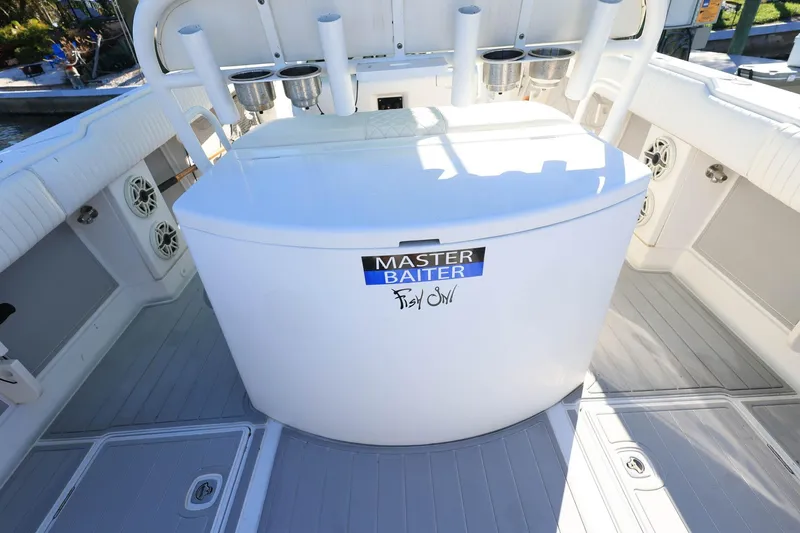  Yacht Photos Pics 2005 Jupiter 38 FS boat deck with fishing rod holders and storage compartment.