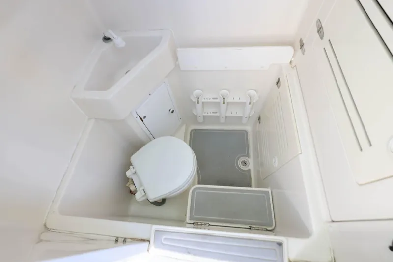  Yacht Photos Pics Compact bathroom in 2005 Jupiter 38 FS boat with sink and toilet.