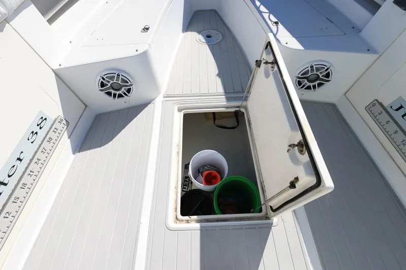  Yacht Photos Pics Open storage compartment on 2005 Jupiter 38 FS boat deck with buckets inside.