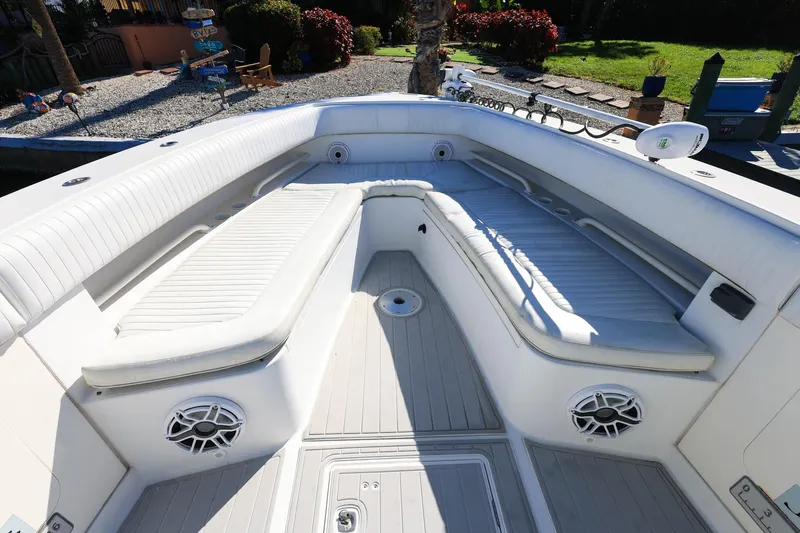  Yacht Photos Pics 2005 Jupiter 38 FS boat interior with white cushioned seating and speakers.