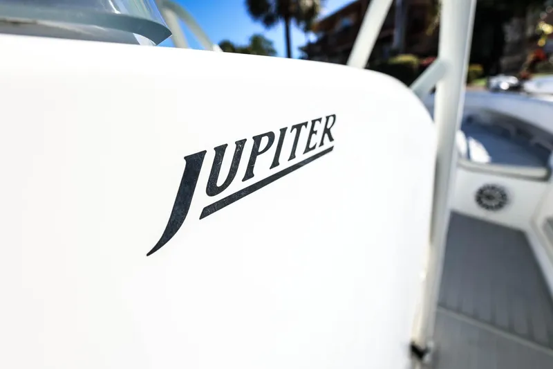  Yacht Photos Pics Close-up of 2005 Jupiter 38 FS boat logo on white surface.