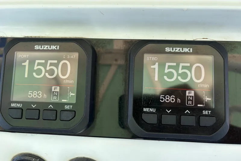  Yacht Photos Pics Suzuki engine displays showing 1550 RPM on a 2005 Jupiter 38 FS boat.