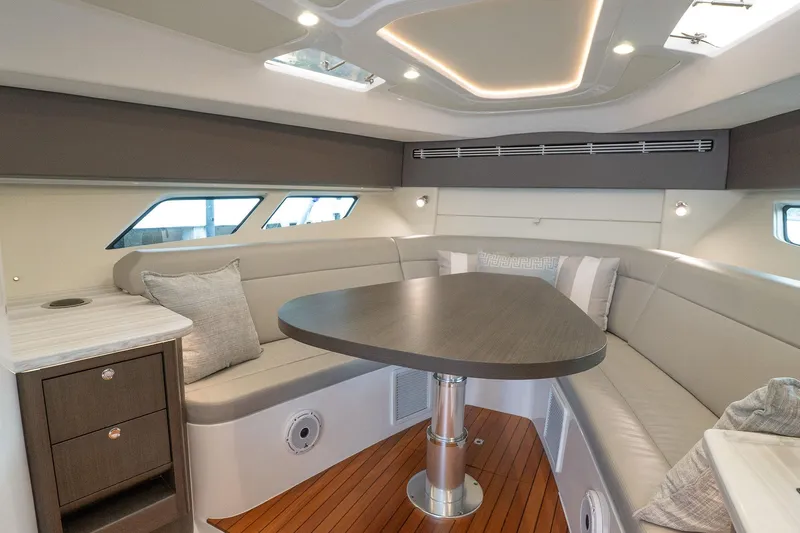 Garbonzo Yacht Photos Pics Luxurious interior of 2022 Intrepid 477 Evolution yacht with elegant seating and modern design.