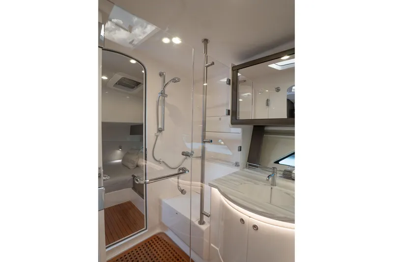 Garbonzo Yacht Photos Pics Luxurious bathroom interior of 2022 Intrepid 477 Evolution yacht, featuring modern shower and sink.