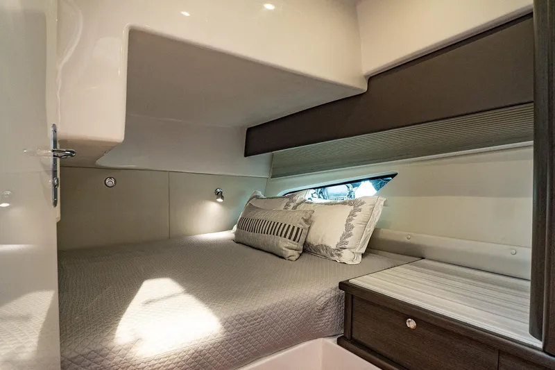 Garbonzo Yacht Photos Pics Luxurious cabin interior of 2022 Intrepid 477 Evolution yacht with cozy bedding.
