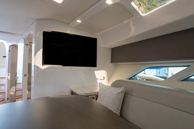 Garbonzo Yacht Photos Pics Luxurious interior of 2022 Intrepid 477 Evolution yacht with modern seating and large TV.