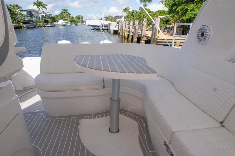 Garbonzo Yacht Photos Pics 2022 Intrepid 477 Evolution yacht interior with elegant seating and table, dockside view.