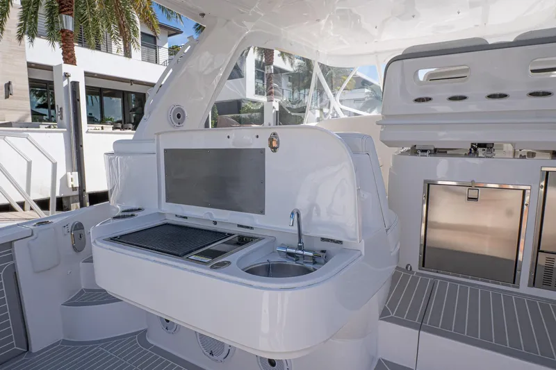 Garbonzo Yacht Photos Pics 2022 Intrepid 477 Evolution yacht interior with modern kitchenette and sleek design.