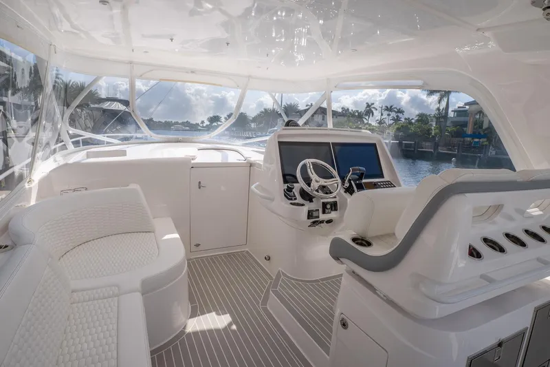 Garbonzo Yacht Photos Pics Luxurious 2022 Intrepid 477 Evolution yacht interior with modern helm and seating.