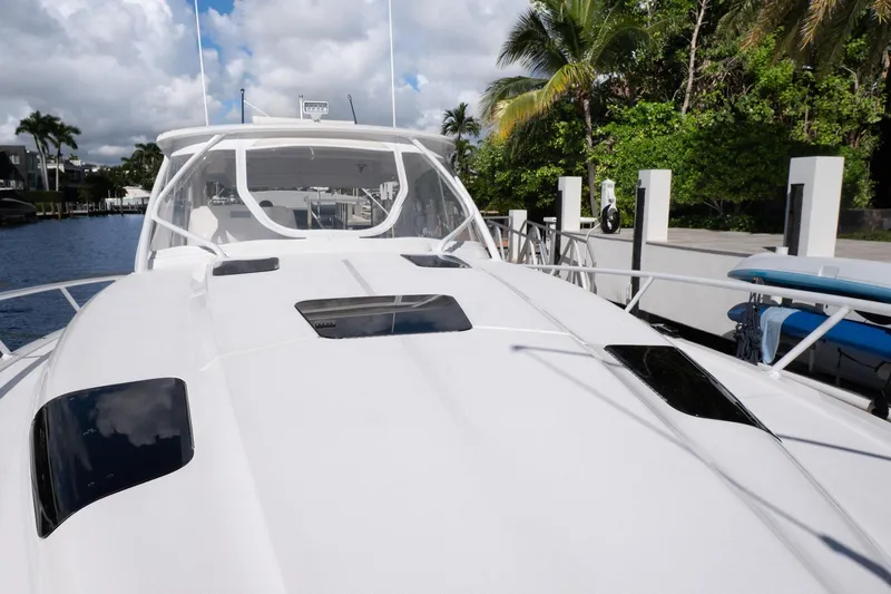 Garbonzo Yacht Photos Pics 2022 Intrepid 477 Evolution yacht docked by tropical waterfront.