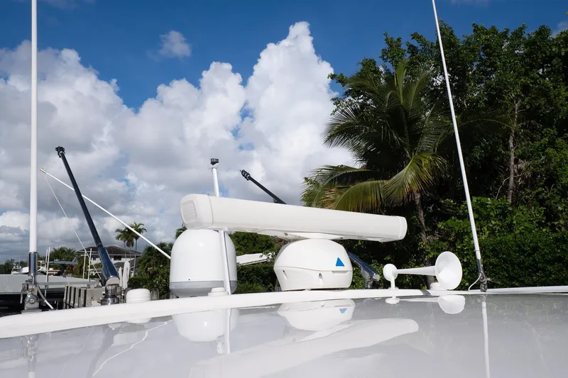 Garbonzo Yacht Photos Pics Rooftop equipment on 2022 Intrepid 477 Evolution boat against a tropical backdrop.