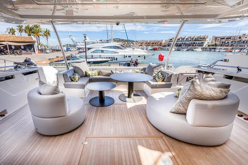  Yacht Photos Pics Luxurious 2020 Ferretti Yachts 960 deck with elegant seating and scenic marina view.