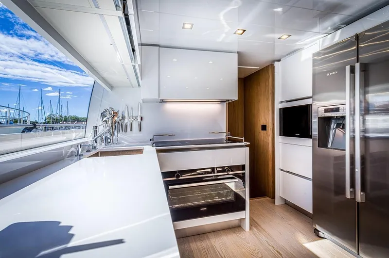  Yacht Photos Pics Modern kitchen interior on 2020 Ferretti Yachts 960, featuring sleek design and stainless steel appliances.