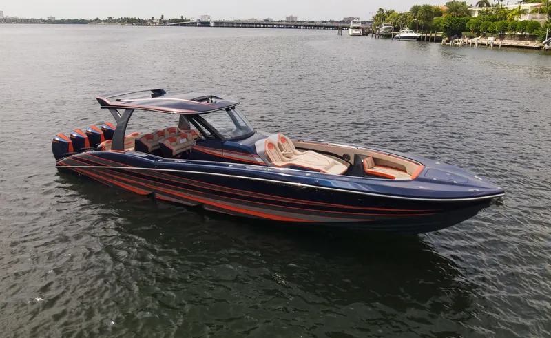 Thunder Struck Yacht Photos Pics 2024 MTI V42 luxury speedboat on calm water, featuring sleek design and vibrant colors.