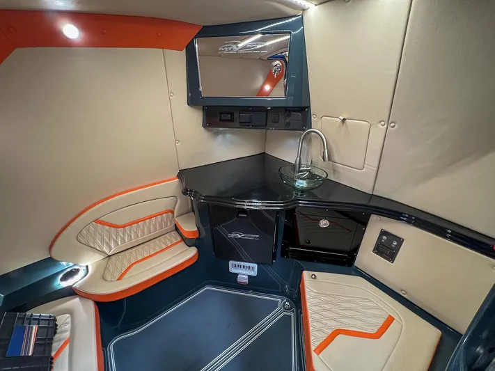 Thunder Struck Yacht Photos Pics 2024 MTI V42 cabin interior with modern seating, sleek design, and compact kitchenette.
